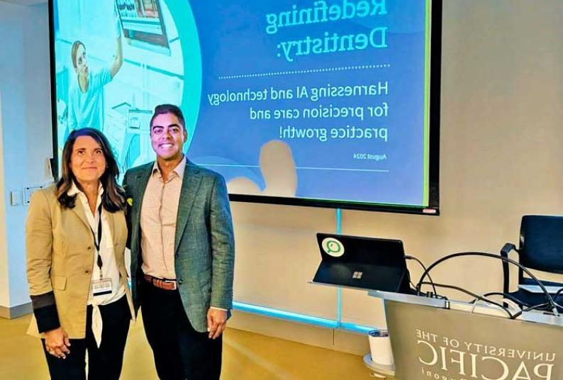 man and woman standing side by side in front of a projection screen in a classroom